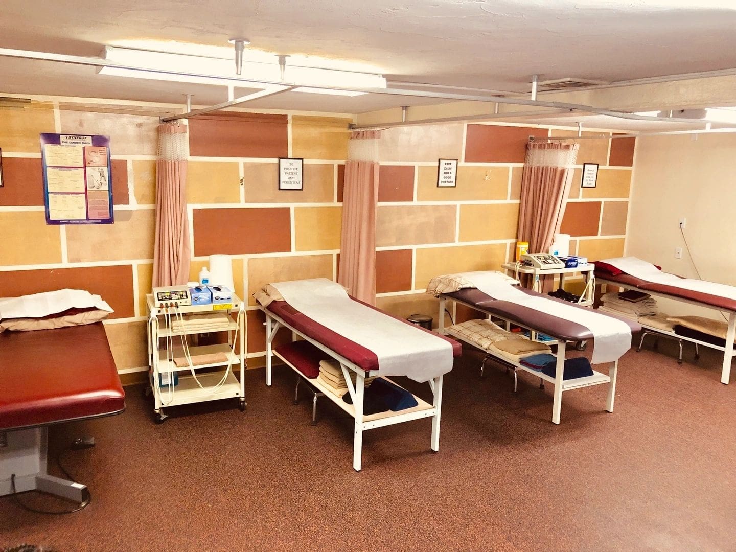 A room with several beds in it